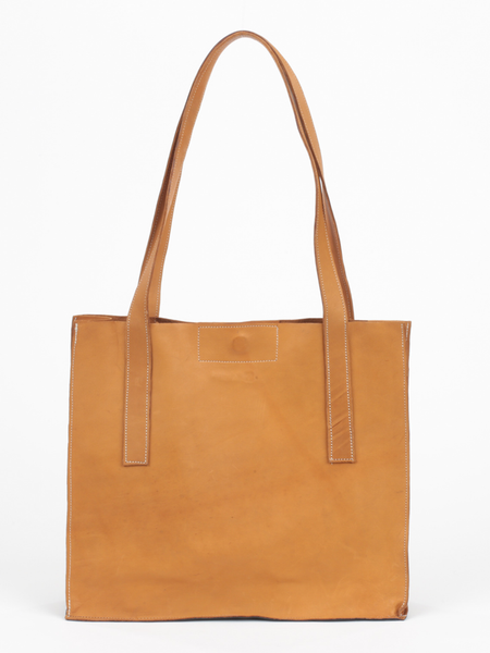 Tan leather Classic City Tote with inner tube bottom panel, and magnetic closure by deux mains. Front view.