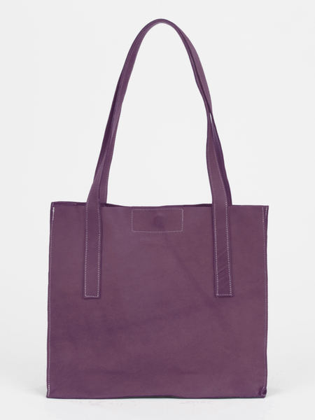 Plum leather Classic City Tote with inner tube bottom panel, and magnetic closure by deux mains. Front view.