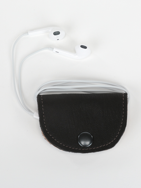 Black and natural leather Bèl Mizik Earbud Holder with snap closure. Front view of product showcasing organized earbuds.