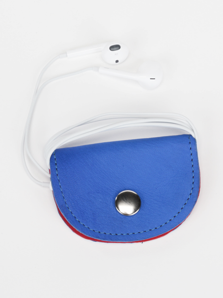 Royal blue and red leather Bèl Mizik Earbud Holder with snap closure. Front view showing the closed royal blue exterior with earbuds wrapped around product.