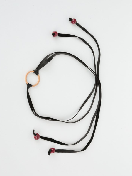 Black leather Bonjou Wrap Bracelet with wooden ring center, and dark red ceramic beads. Top view arranged in a loop.