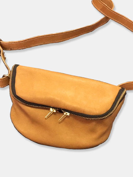 Tan leather fanny pack with double zipper closure and adjustable strap. The Lore by deux mains. Front view.
