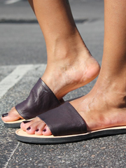 Leather Anne Sandals with Upcycled Tire Tread Soles, and Plum Upper by deux mains. Detailed shot of sandal from side with female model.