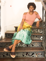 Leather Anne Sandals with Upcycled Tire Tread Soles, and Plum Upper by deux mains. Wide shot of female model in long skirt on a staircase. 