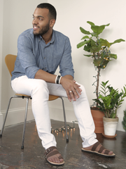 Leather Bel Nanm for Him Sandals with Upcycled Tire Tread Soles, and Brown Upper by deux mains. Bodyshot of male model sitting in a chair. 