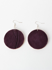 Plum leather Circle of Love Earrings with laminated pine dowel discs. Front view showing tan leather side of earrings. 