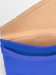 Royal blue leather City Classic Clutch, with natural leather interior by deux mains. Close up of open clutch showing natural leather interior, stitching details and deux mains logo. 