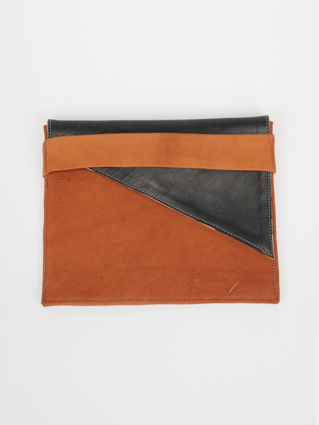 Tan leather City Classic Clutch, with diagonal black contrast fold-over by deux mains. Front view.