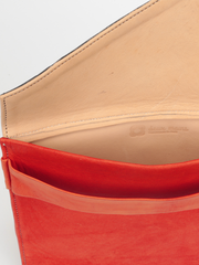 Red leather City Classic Clutch, with natural leather interior by deux mains. Close up of open clutch showing natural leather interior, stitching details and deux mains logo. 