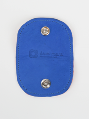 Denim and inner tube Bèl Mizik Earbud Holder with snap closure. Exterior view showing the open royal blue leather.