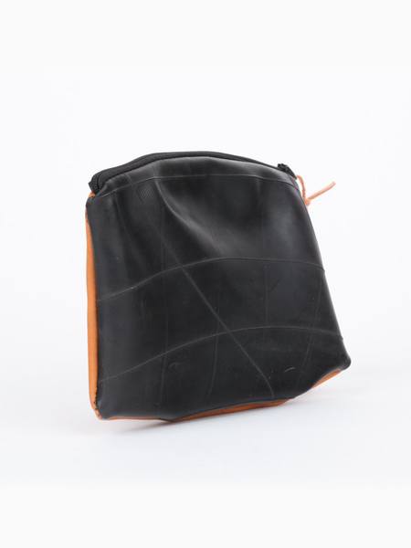 Inner tube and tan leather Maudernise Pouch with zipper closure, by deux mains. Front view.