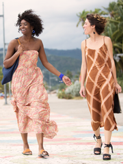 Royal blue leather Bonjou Wrap Bracelet with wooden ring center, and cream ceramic beads. Shot of two female models walking down a windy street.  