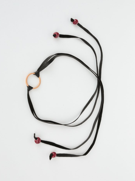 Black leather Bonjou Wrap Bracelet with wooden ring center, and dark red ceramic beads. Top view arranged in a loop. 